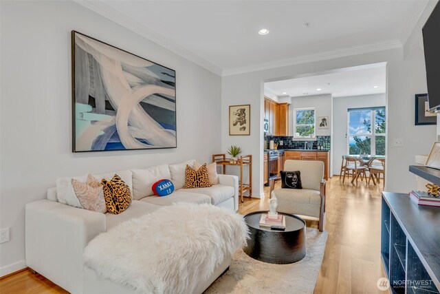 living room with crown molding, recessed lighting, and light wood-type flooring