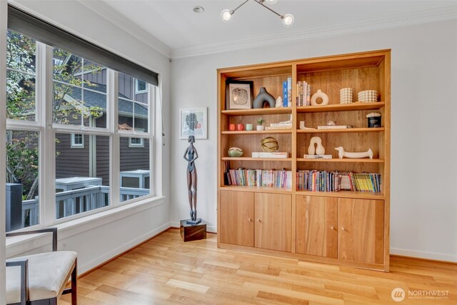 sitting room featuring baseboards, a chandelier, ornamental molding, and wood finished floors