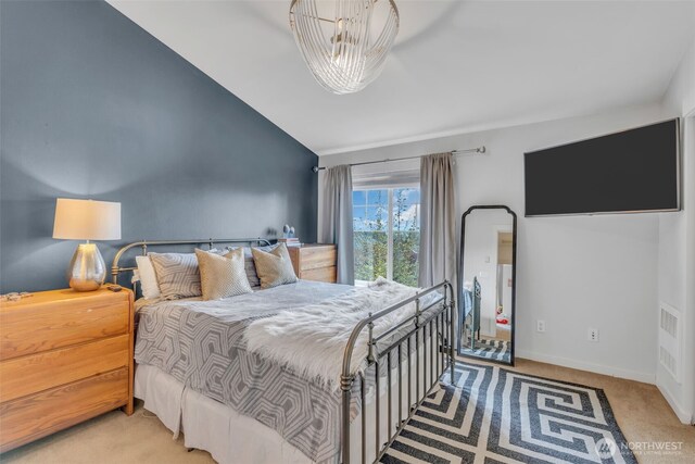 bedroom with baseboards, light colored carpet, and vaulted ceiling