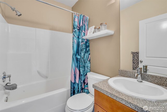 bathroom featuring vanity, toilet, and shower / tub combo