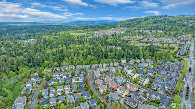 birds eye view of property with a residential view and a wooded view