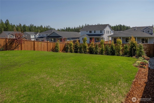 view of yard with fence and a residential view