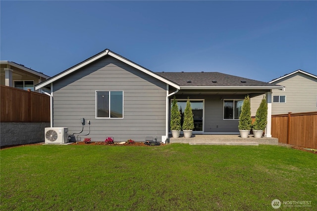 rear view of property with a patio area, ac unit, fence, and a yard