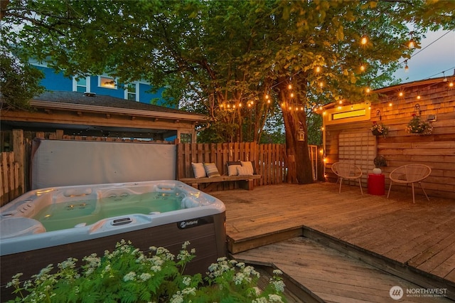 wooden deck with hot tub deck surround and fence