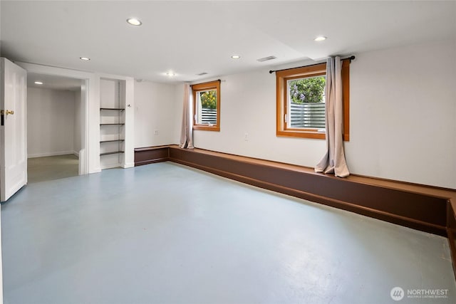unfurnished living room featuring concrete flooring, visible vents, and recessed lighting