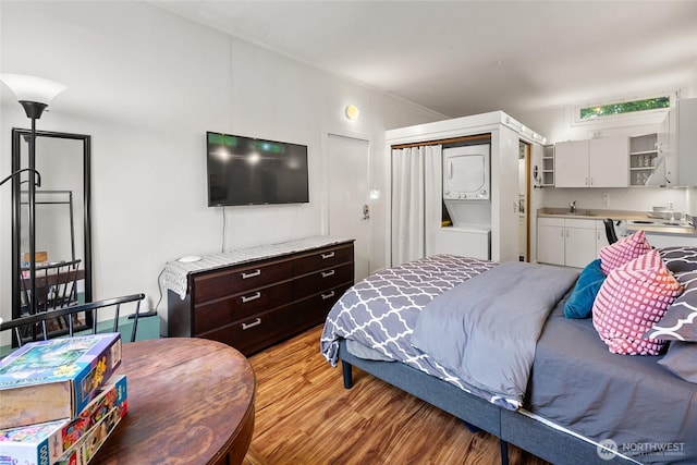 bedroom with a sink and light wood-type flooring