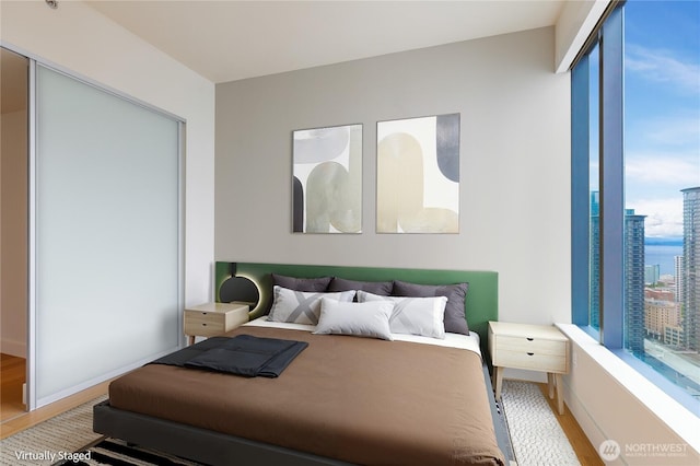 bedroom with light wood-style floors and baseboards