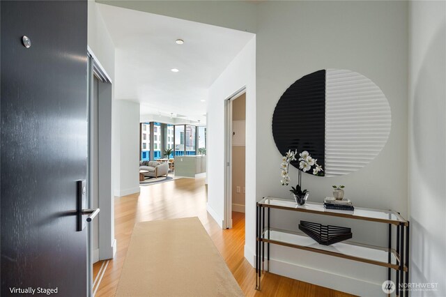 corridor featuring recessed lighting and light wood-style flooring