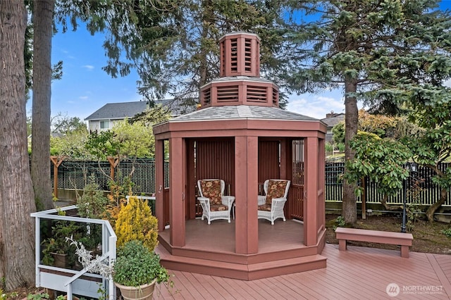 view of outbuilding with fence and a gazebo