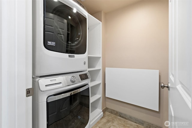 laundry area featuring stacked washer and dryer and laundry area