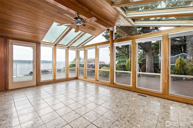 unfurnished sunroom featuring visible vents, a water view, tile patterned floors, vaulted ceiling with skylight, and wooden ceiling