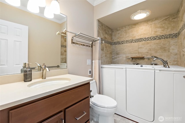 full bath with a tub, vanity, ornamental molding, and toilet