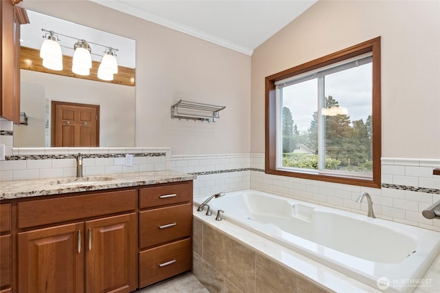bathroom featuring crown molding, vanity, and a bath