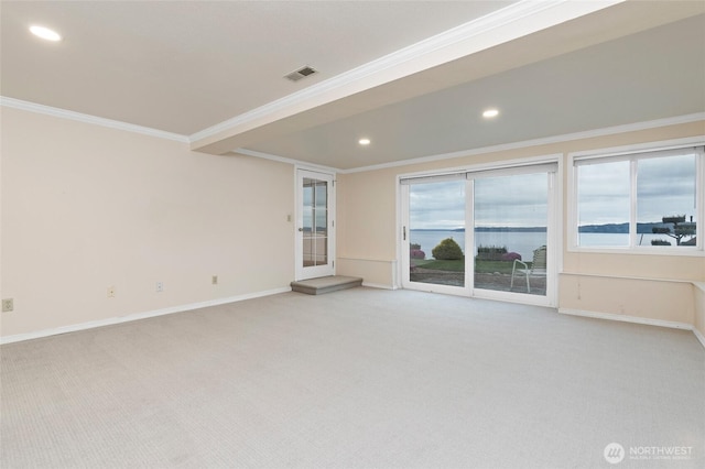 spare room with visible vents, baseboards, ornamental molding, light carpet, and recessed lighting