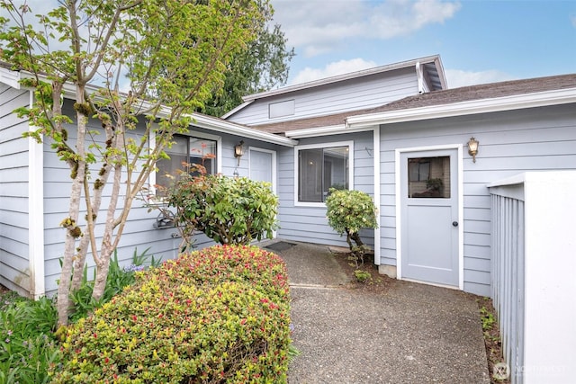 view of front of house with a shingled roof