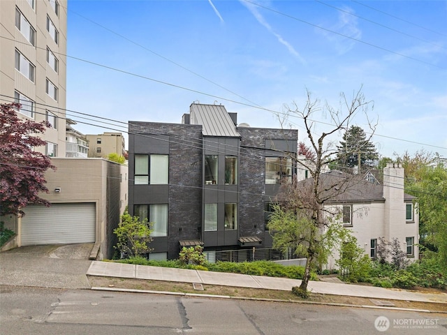 modern home featuring concrete driveway and a garage