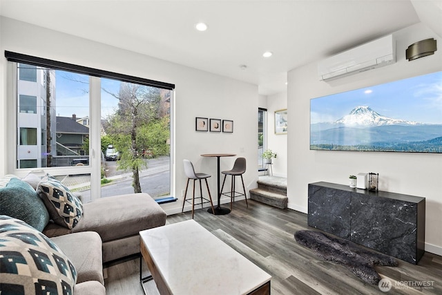 living room featuring wood finished floors, recessed lighting, baseboards, and a wall mounted AC