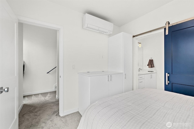 carpeted bedroom with baseboards, a barn door, a sink, and a wall mounted AC