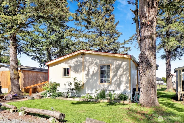view of side of property with a lawn