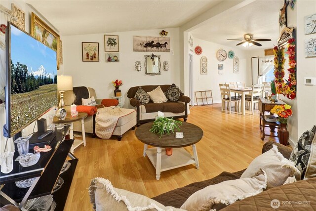 living room featuring a ceiling fan and wood finished floors