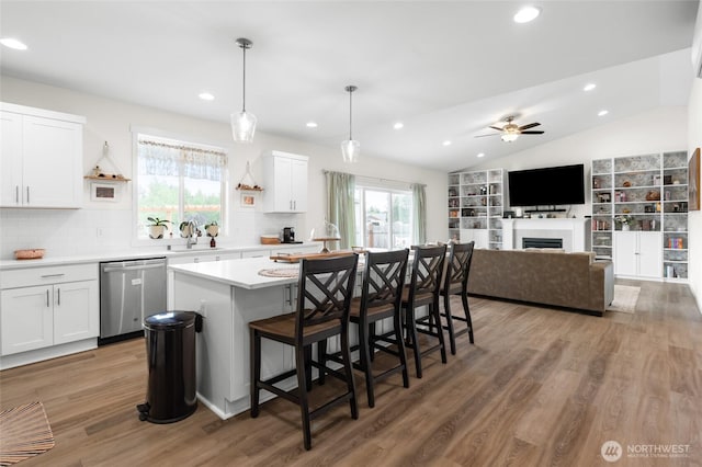 802 SE Cody St, Rainier, WA 98576 - kitchen featuring stainless steel dishwasher, a sink, light countertops, white cabinetry, and recessed lighting