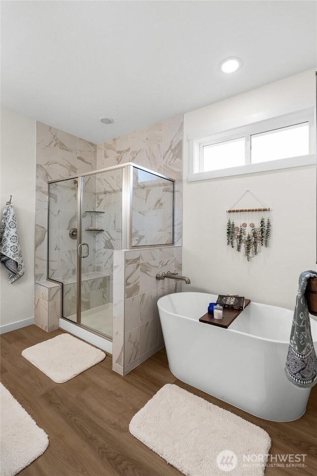 802 SE Cody St, Rainier, WA 98576 - full bath with a soaking tub, a marble finish shower, and wood finished floors