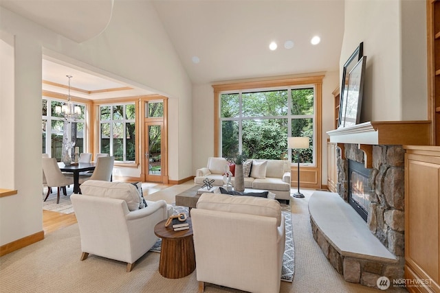 living room with a fireplace, a chandelier, recessed lighting, baseboards, and vaulted ceiling
