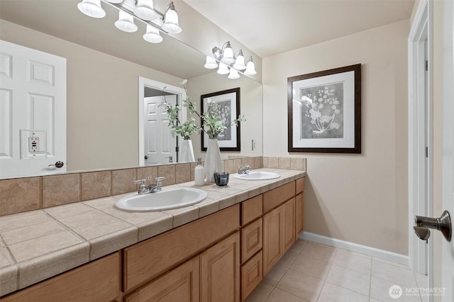 bathroom with tile patterned flooring, a sink, baseboards, and double vanity