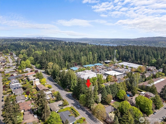 drone / aerial view with a residential view and a view of trees