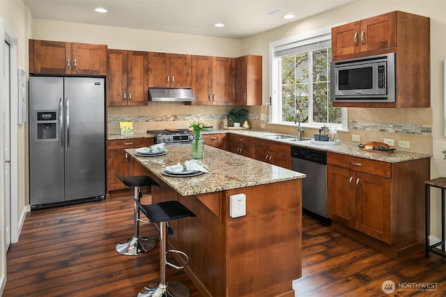 365 NE Denny Way, Issaquah, WA 98029 - kitchen featuring stainless steel appliances, under cabinet range hood, dark wood-style floors, light stone countertops, and recessed lighting