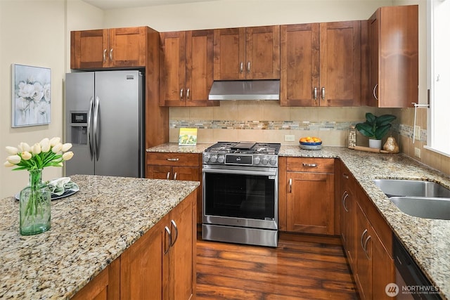 365 NE Denny Way, Issaquah, WA 98029 - kitchen with stainless steel appliances, under cabinet range hood, light stone counters, backsplash, and dark wood-style floors