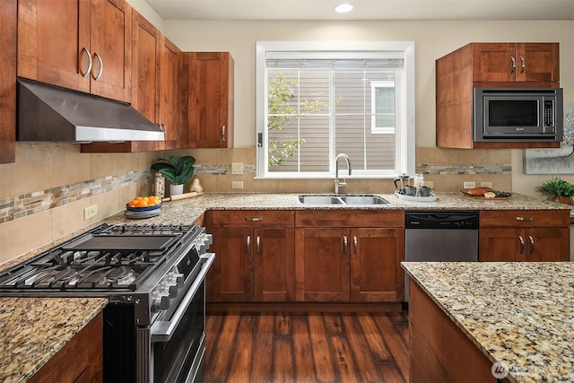 365 NE Denny Way, Issaquah, WA 98029 - kitchen with appliances with stainless steel finishes, under cabinet range hood, a sink, dark wood-type flooring, and light stone counters