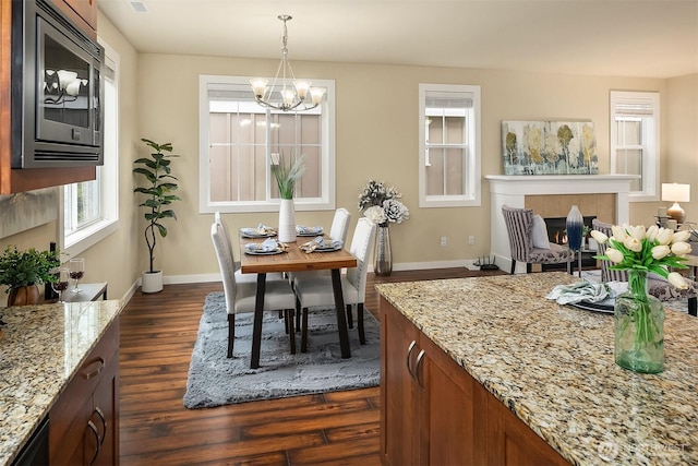 365 NE Denny Way, Issaquah, WA 98029 - dining space with a chandelier, dark wood-type flooring, baseboards, and a tiled fireplace