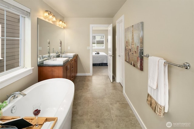 365 NE Denny Way, Issaquah, WA 98029 - full bath with a bathtub, double vanity, connected bathroom, baseboards, and tile patterned floors