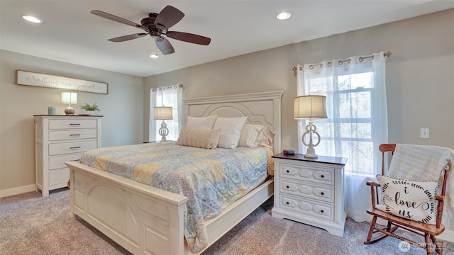 bedroom with recessed lighting, ceiling fan, multiple windows, and light carpet