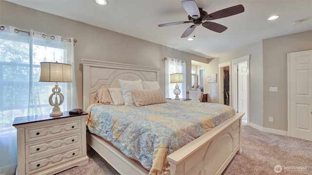 bedroom featuring recessed lighting, a ceiling fan, light colored carpet, and a spacious closet