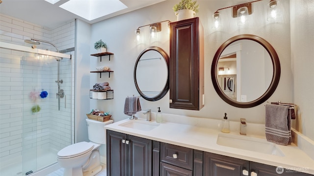 full bathroom featuring a sink, a stall shower, toilet, and a skylight