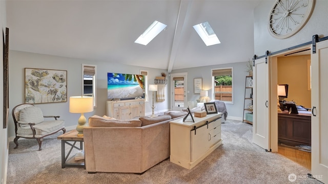 living area with light colored carpet, a barn door, high vaulted ceiling, baseboards, and a skylight