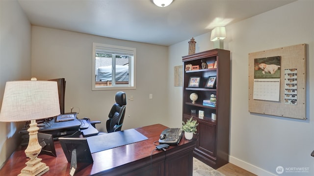 office space featuring light wood-style floors and baseboards