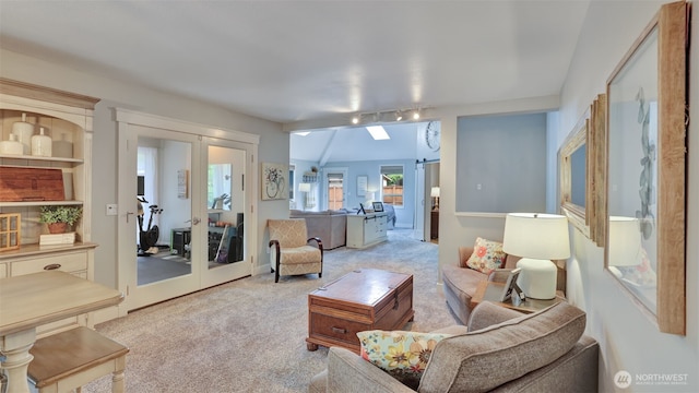 carpeted living room with track lighting and french doors