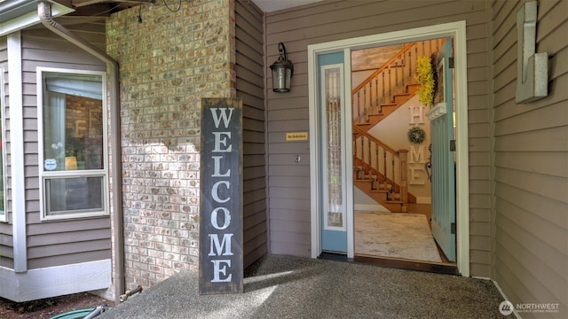 doorway to property with brick siding