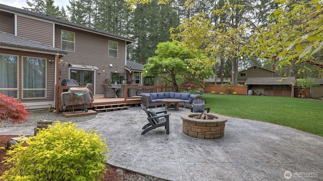 view of patio / terrace featuring an outdoor living space with a fire pit, a wooden deck, and fence