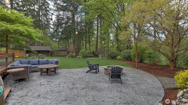 view of patio / terrace featuring an outbuilding and an outdoor living space with a fire pit