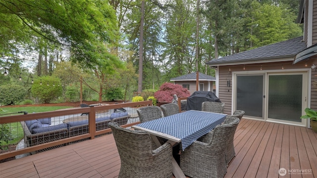 wooden terrace featuring outdoor dining space and area for grilling
