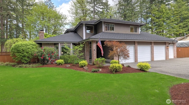 view of front of house with driveway, a chimney, roof with shingles, brick siding, and a front lawn