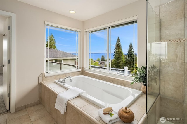 bathroom with tile patterned flooring and a garden tub