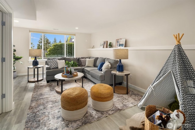 living area featuring recessed lighting, baseboards, and wood finished floors