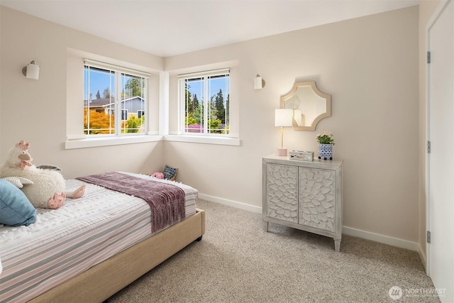 bedroom featuring baseboards and carpet