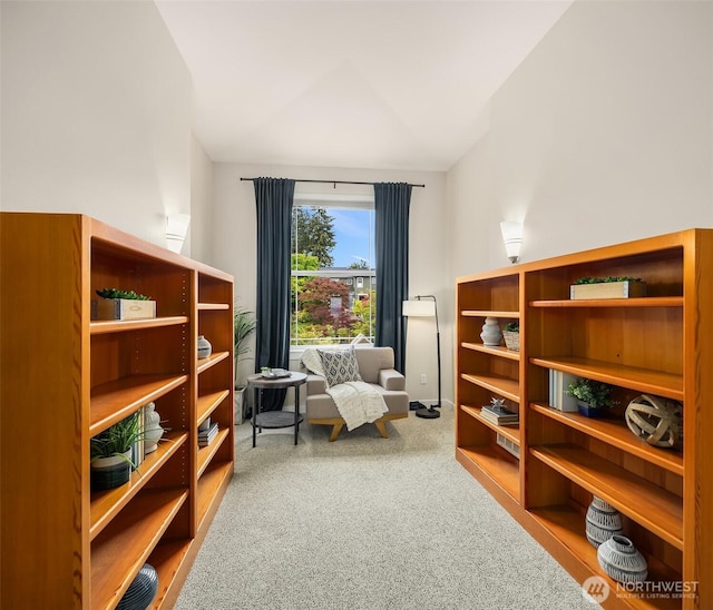 sitting room with carpet flooring and vaulted ceiling