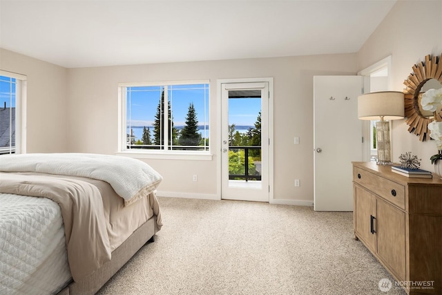 bedroom featuring baseboards, light colored carpet, and access to exterior